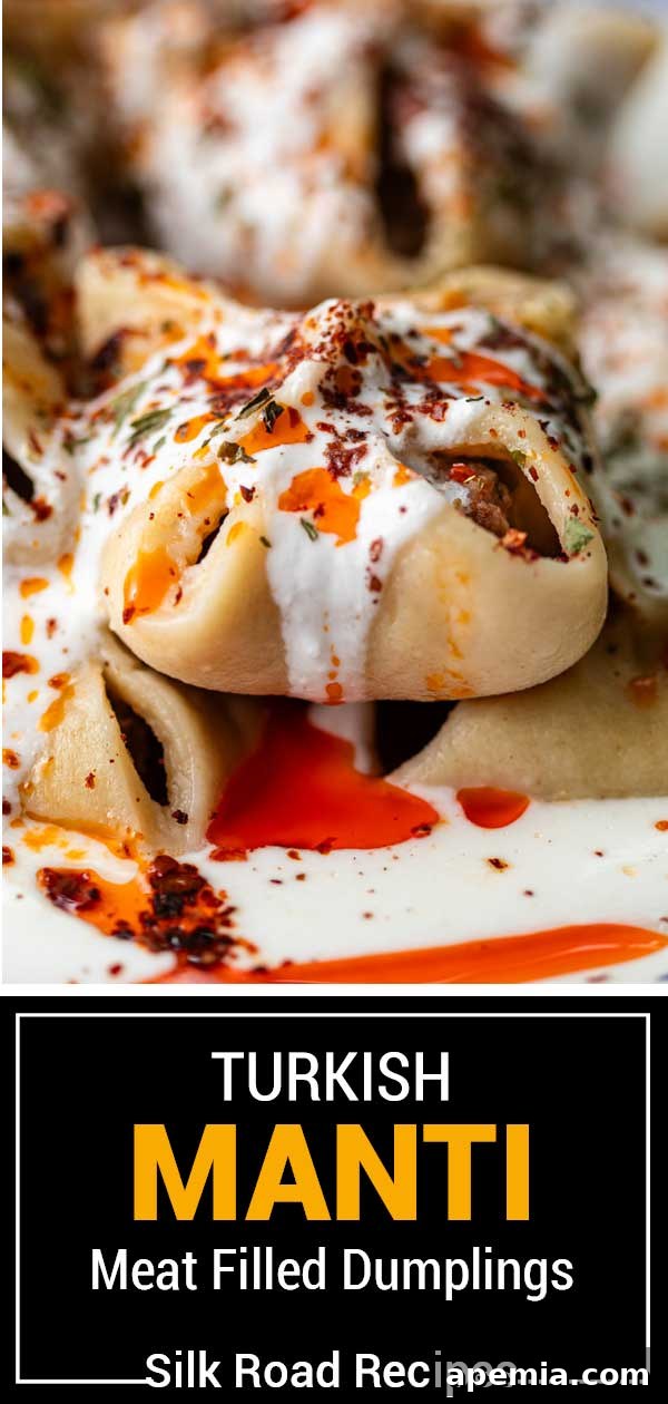 Manti dumplings artfully arranged and generously drizzled with a rich chili oil, showcasing the vibrant colors and textures.