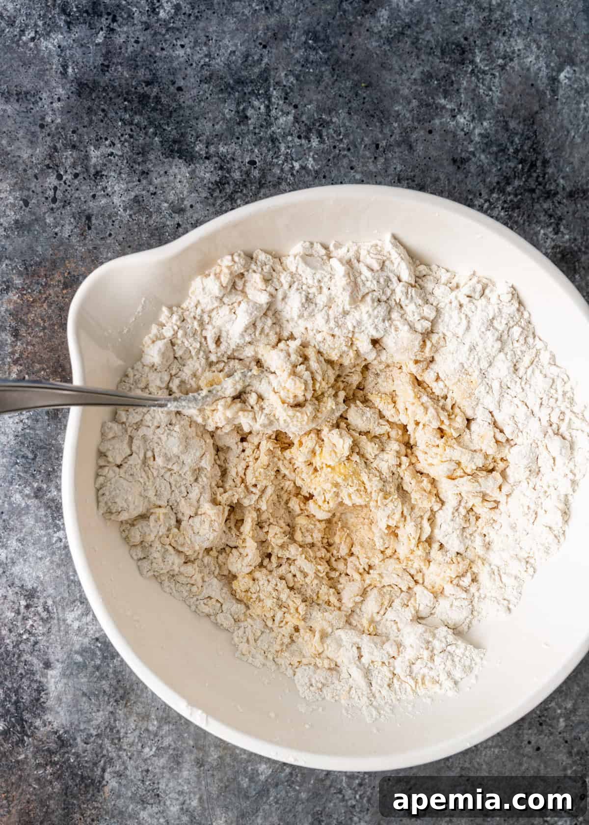 Overhead process shot: Hands actively kneading the dough for Manti on a clean surface.