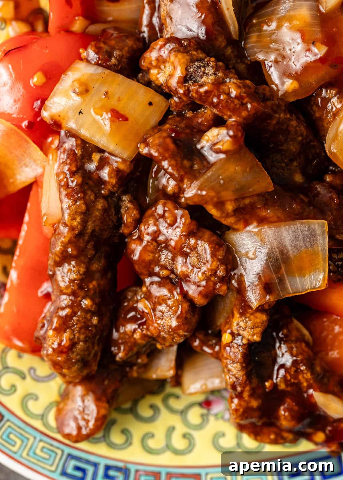 Sweet & Tangy Beijing Beef 7 Extreme close-up of Beijing Beef stir fry, showcasing the glossy, sticky sauce coating every piece of beef and vibrant vegetable