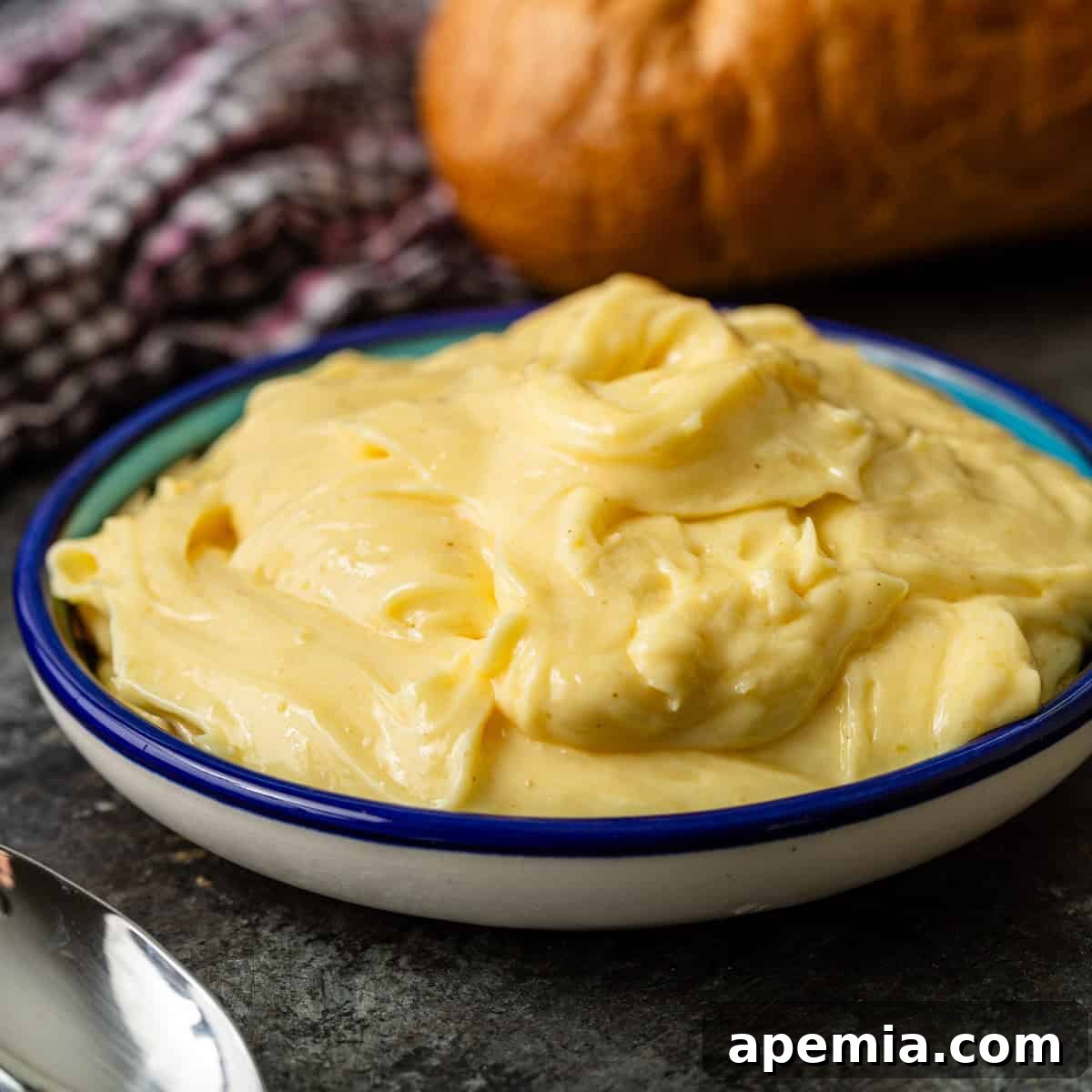 closeup: a bowl of vibrant yellow Vietnamese mayo, showcasing its rich texture and color