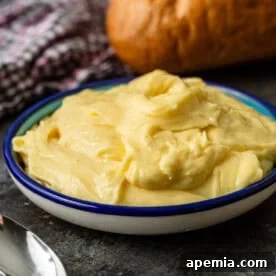 A perfectly emulsified bowl of homemade Vietnamese Mayo Butter, with a golden hue.