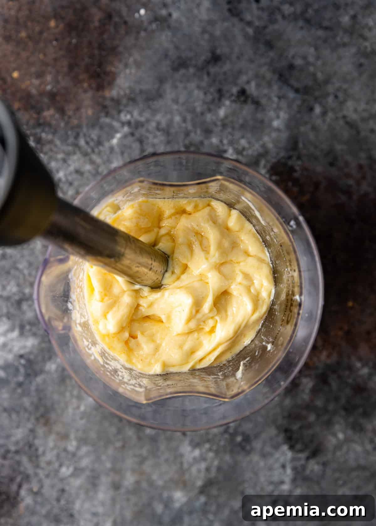 overhead process shot: blending mayo in immersion blender almost fully blended
