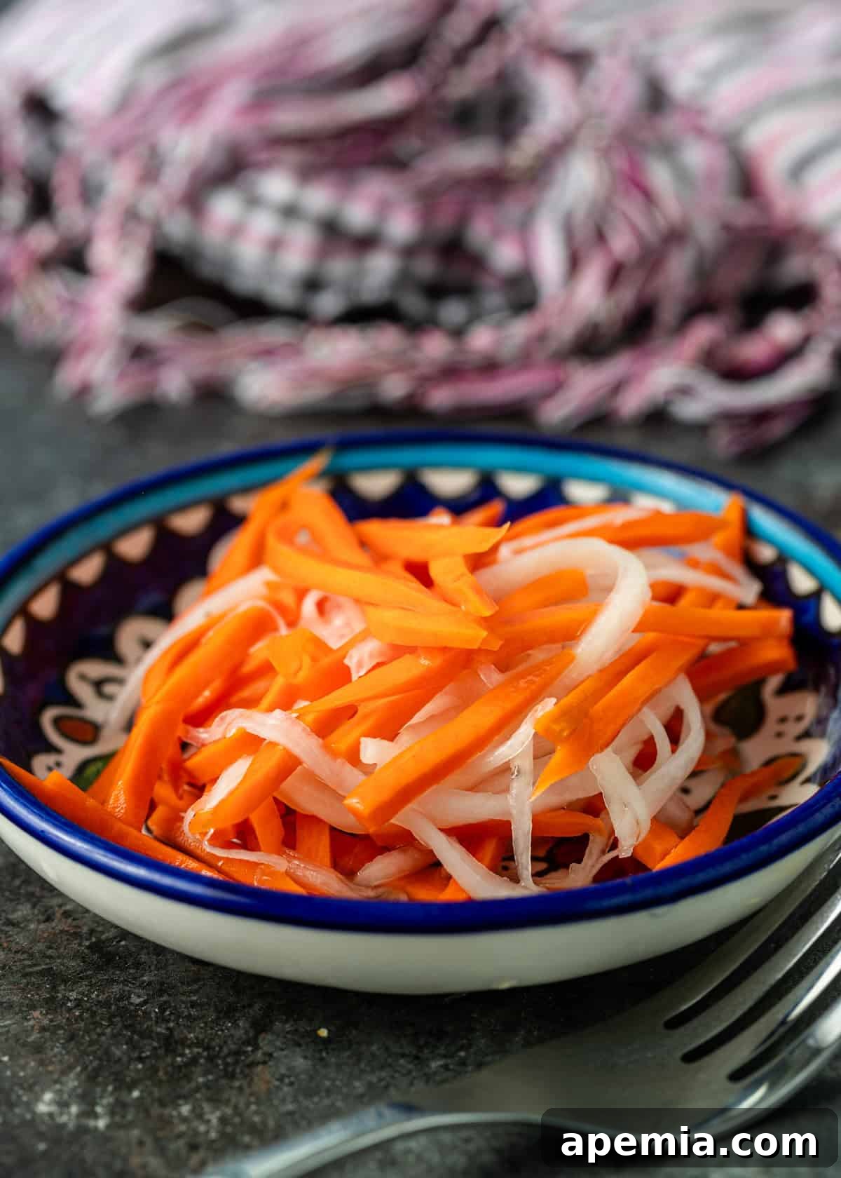 side view: pickled carrot and daikon in a small bowl