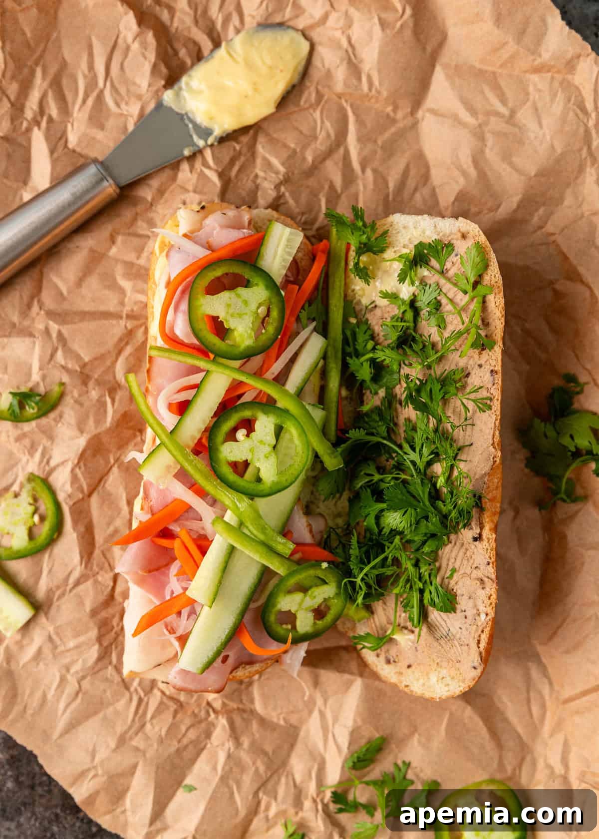 overhead: topping my banh mi recipe with peppers, cucumber, and cilantro