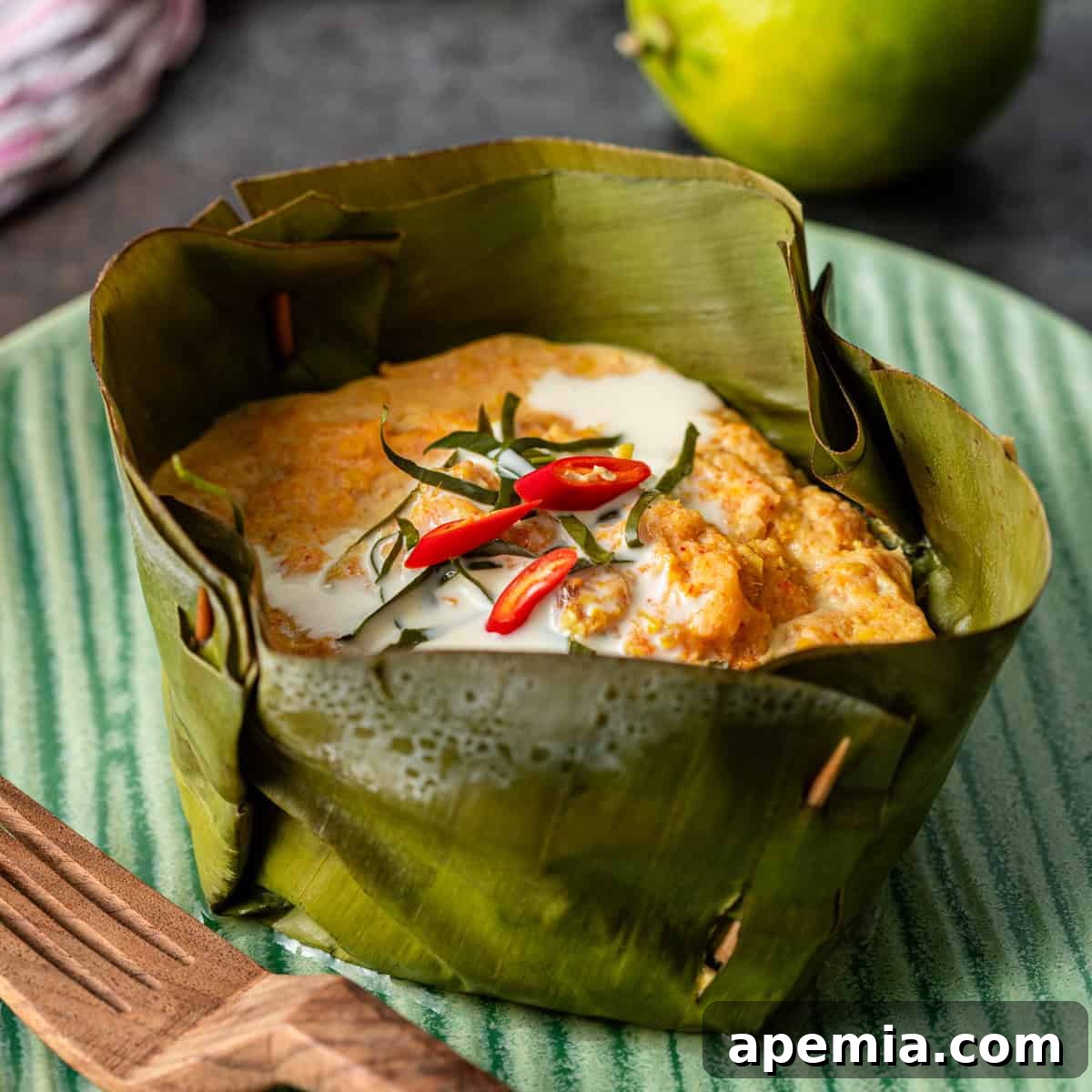 closeup: my fish amok recipe in a banana leaf on a green ceramic plate