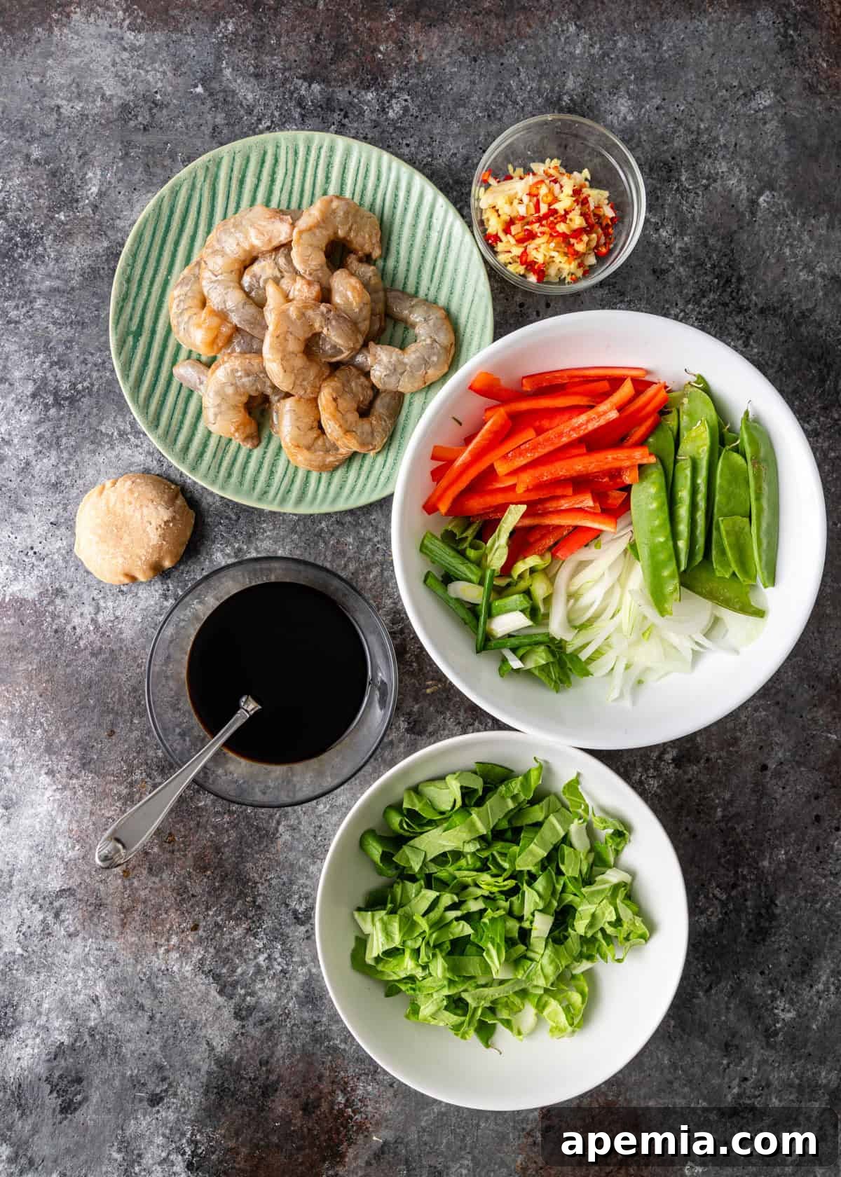 Bold and Spicy Thai Basil Noodles 5 Overhead process shot displaying all the prepped ingredients for Pad Kee Mao (Drunken Noodles) laid out on a cutting board, ready for stir-frying.