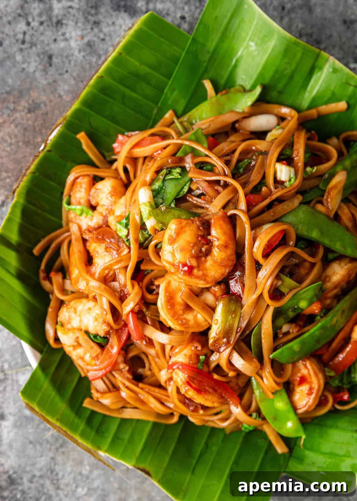 Bold and Spicy Thai Basil Noodles 8 Overhead shot of my Drunken Noodles recipe elegantly served in a bowl, placed on banana leaves for an authentic presentation.