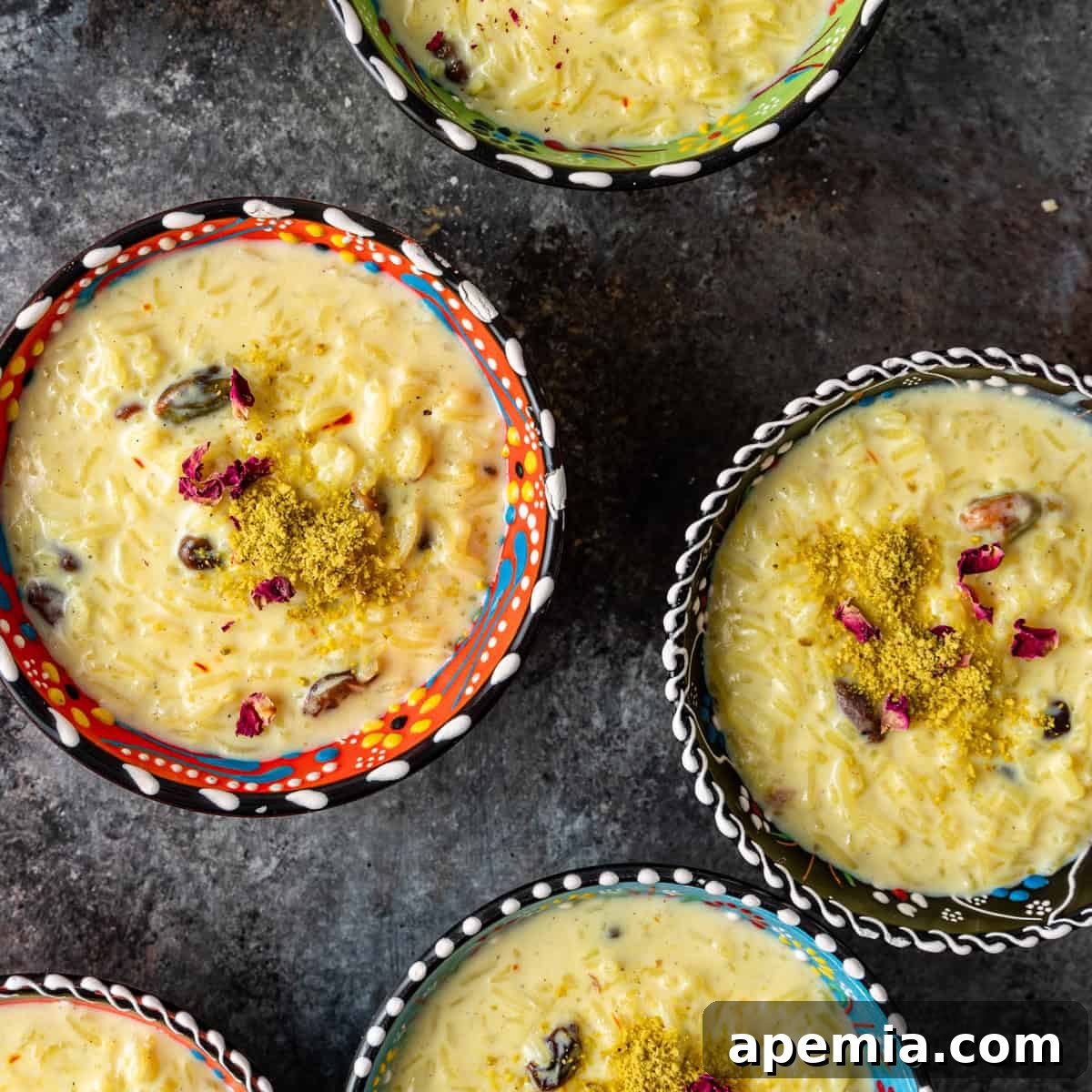Indian Kheer Sweet Perfection 2 overhead: several bowls of kheer with dried rose petals and crushed pistachios on top
