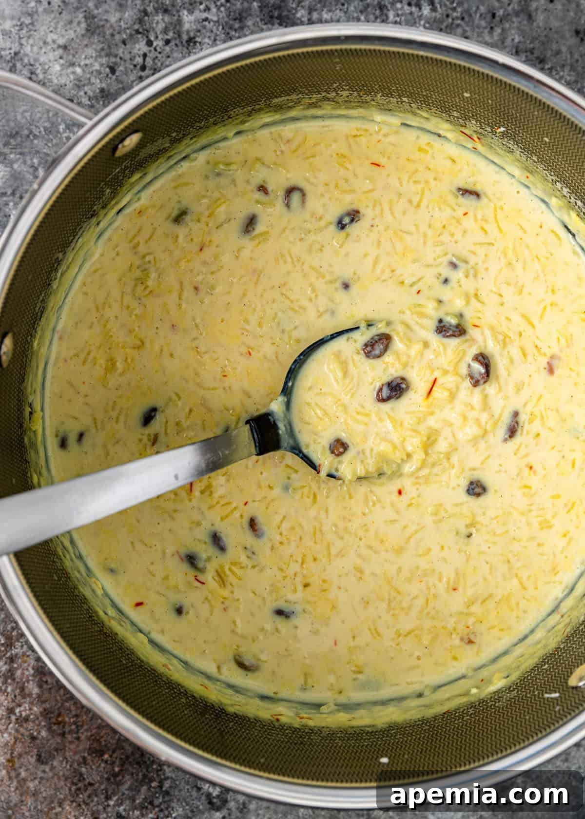 Indian Kheer Sweet Perfection 6 overhead: a large metal spoon in a large pot full of my kheer recipe