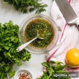 Overhead image of a small glass bowl of Mediterranean chicken marinade, ready to use for cooking.