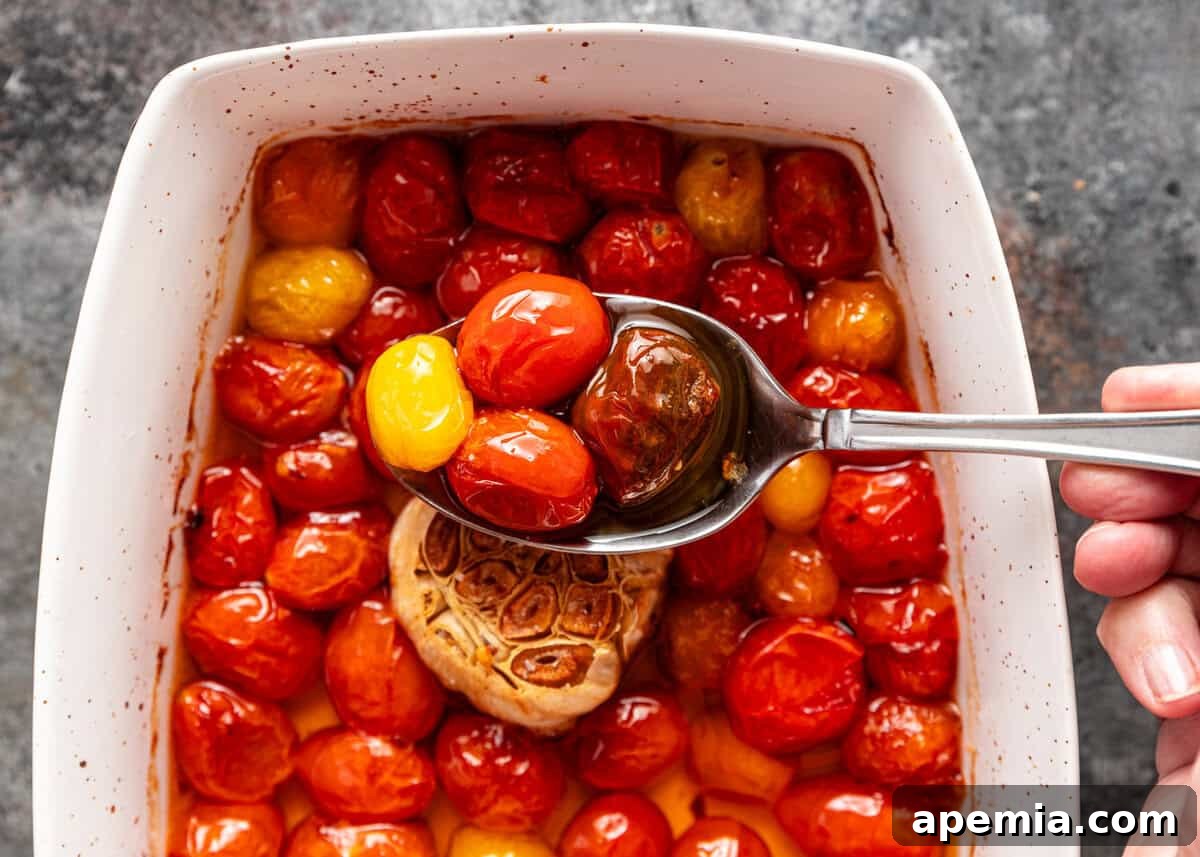 Overhead shot: a single spoonful of my homemade tomato confit recipe, glistening with infused oil.