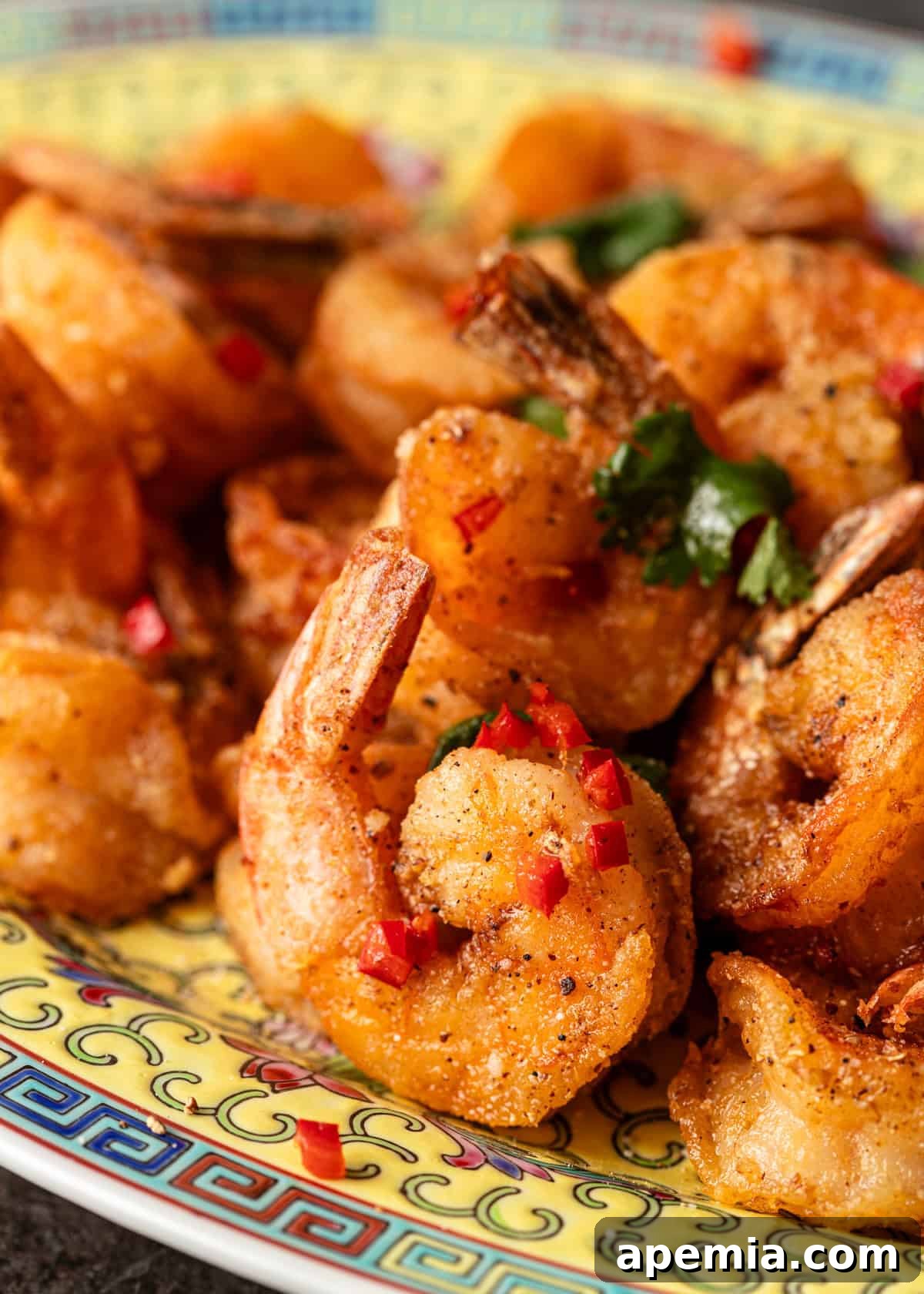 extreme closeup: salt and pepper shrimp stir fry with seasonings and chiles