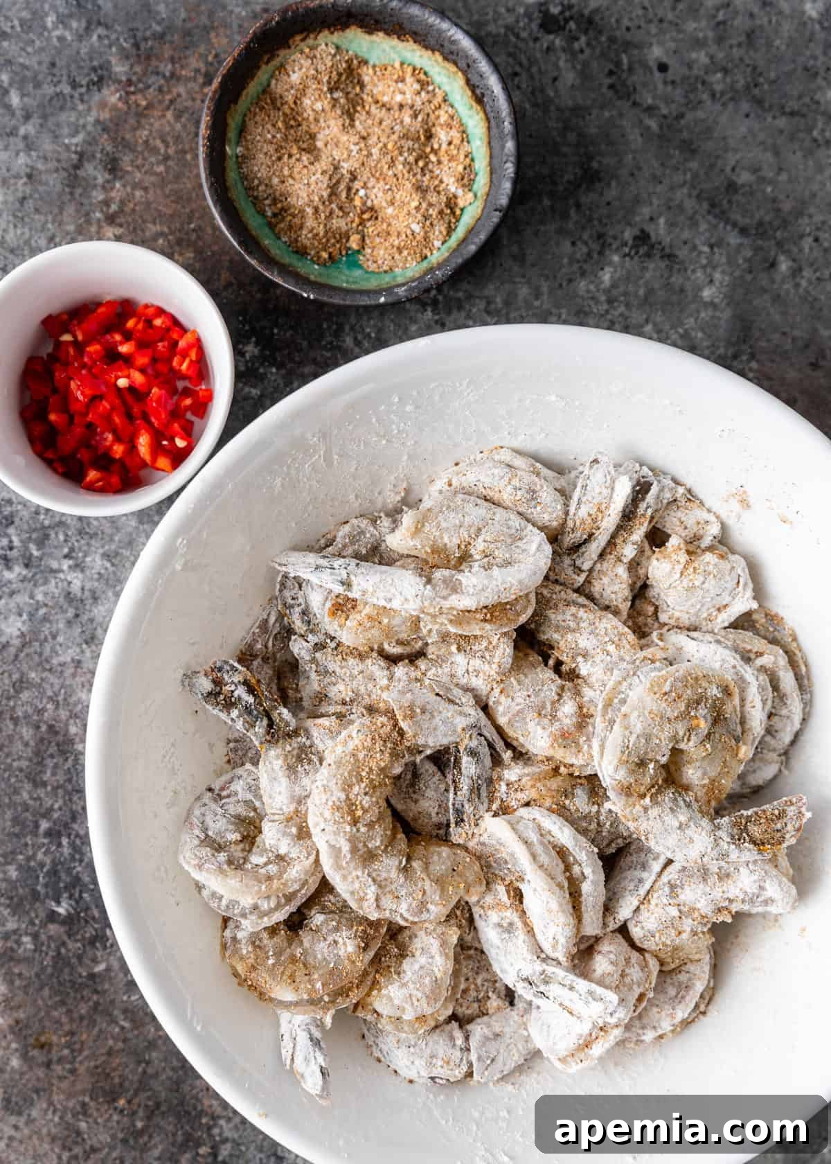 overhead: prepped shrimp, spices, and chiles for salt and pepper shrimp stir fry