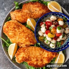 Perfectly golden, crispy chicken Milanese served with fresh Caprese salad and arugula.