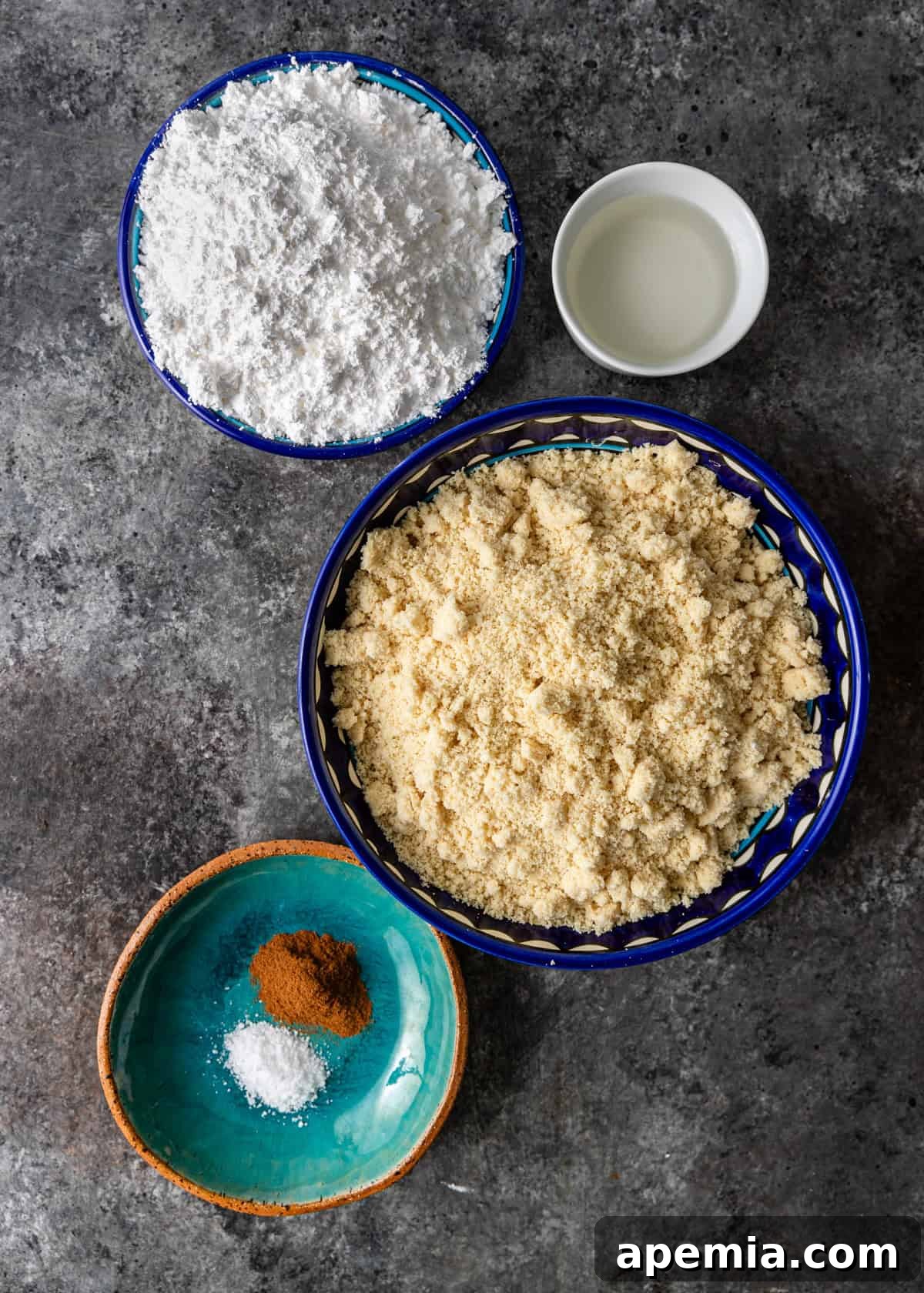 Mhencha: Moroccan Coiled Almond Delight 4 Overhead shot of all ingredients laid out for the Mhencha recipe, including almond flour, sugar, cinnamon, orange blossom water, and filo pastry.