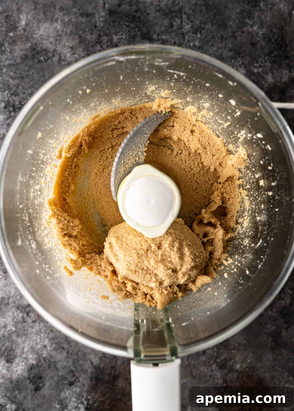 Mhencha: Moroccan Coiled Almond Delight 7 Overhead process shot: almond flour, sugar, cinnamon, and salt after blending, forming a fine mixture ready for liquid.