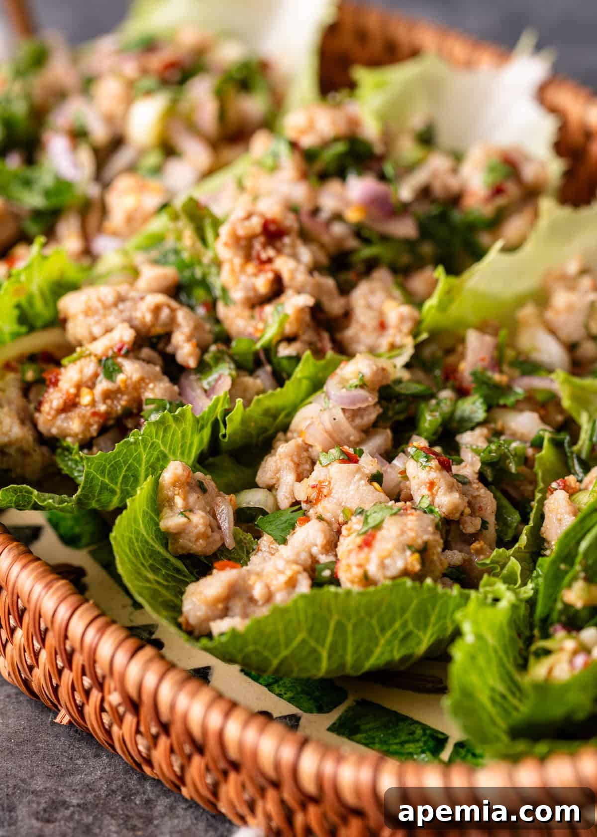 Zesty Thai Larb Gai Chicken Lettuce Wraps 3 closeup: my thai chicken lettuce wrap recipe in a wicker serving dish