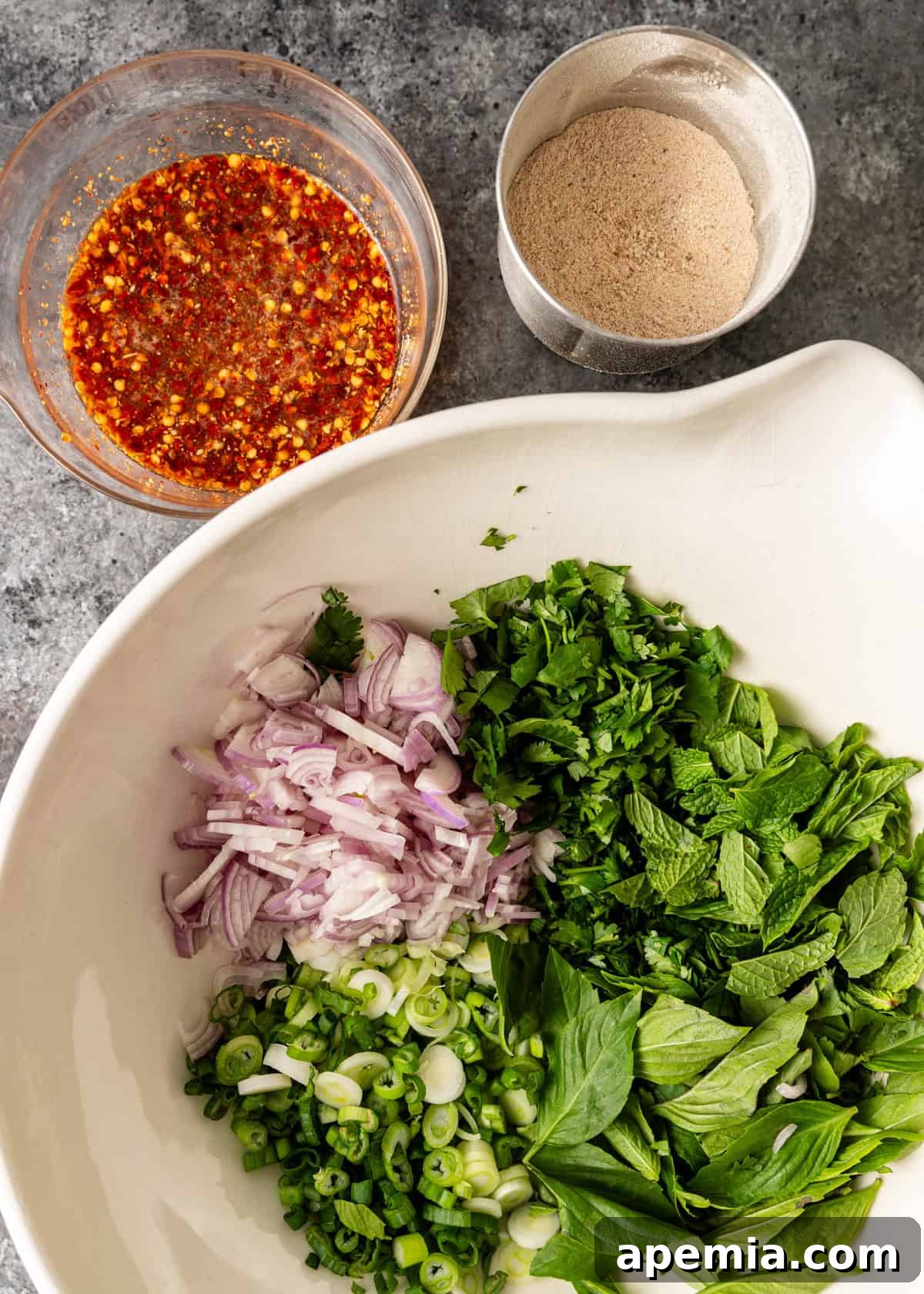 Zesty Thai Larb Gai Chicken Lettuce Wraps 8 overhead: herbs and onions to make larb gai in a large mixing bowl before mixing