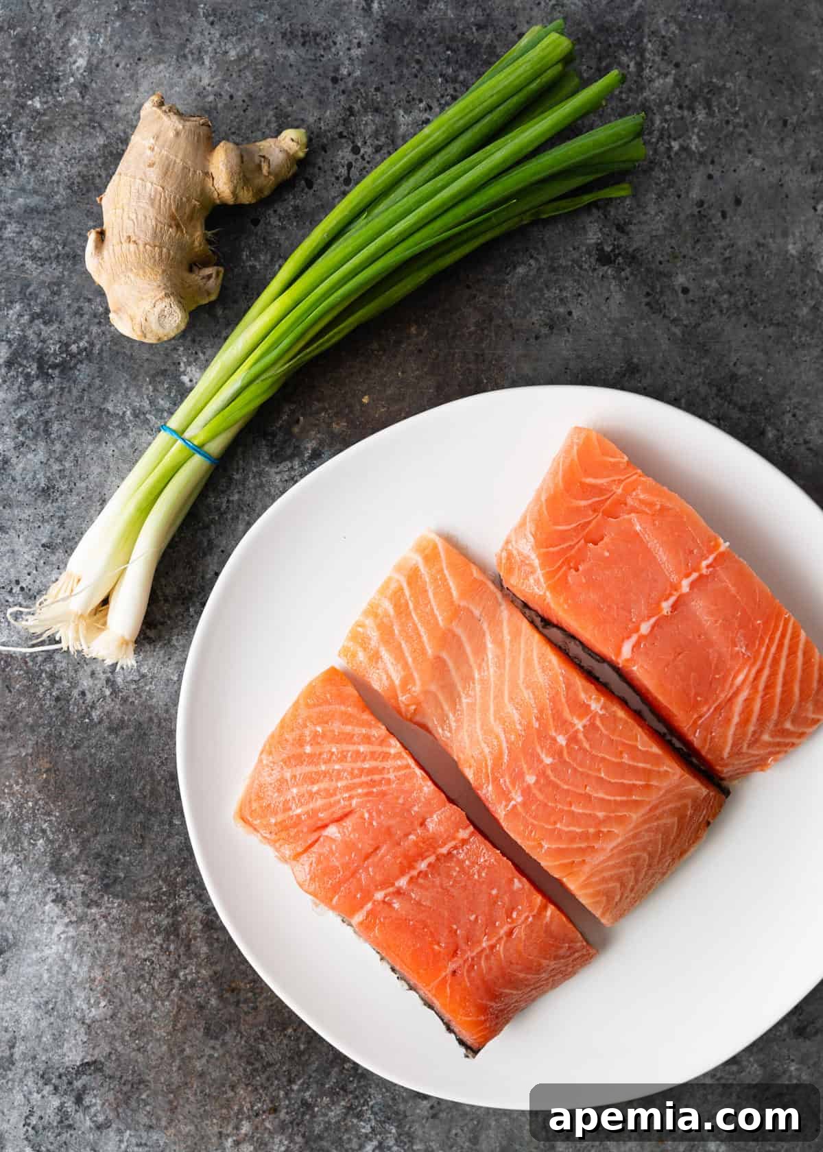 Overhead shot of all the fresh ingredients required to prepare the baked salmon recipe