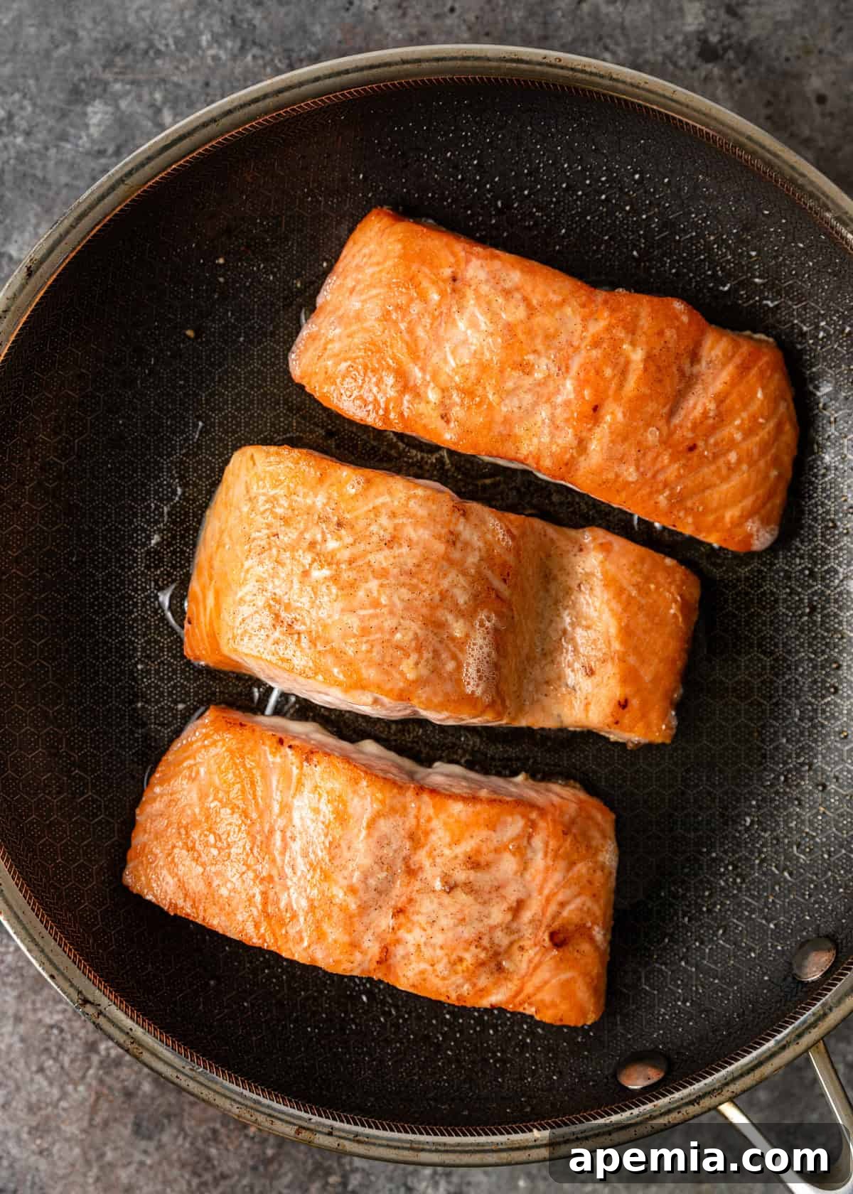 Overhead shot of the baked salmon recipe simmering in a skillet