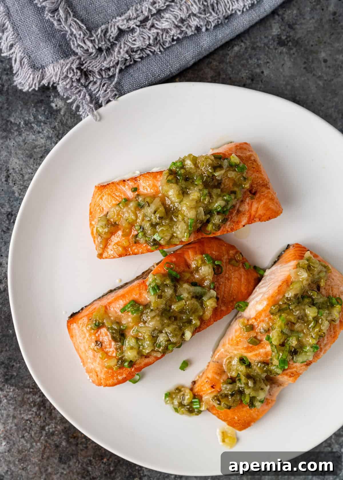 Overhead shot of my baked salmon recipe generously topped with vibrant ginger scallion sauce