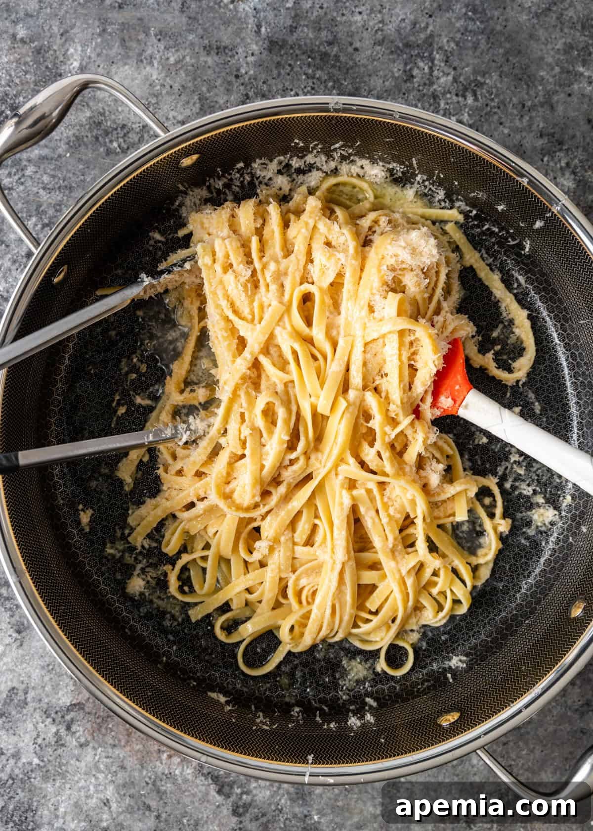 overhead process shot: tossing the pasta to further melt the butter to coat