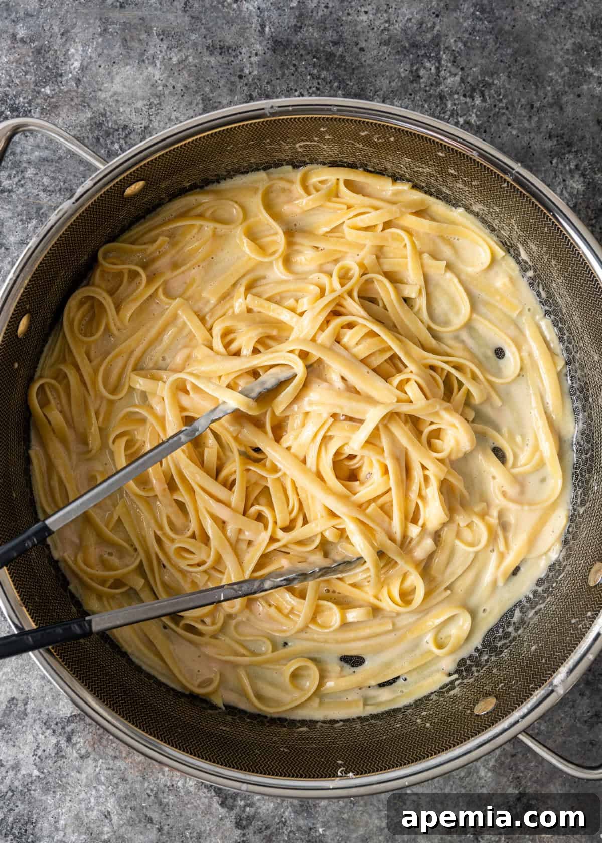 overhead process shot: adding the pasta water to the skillet
