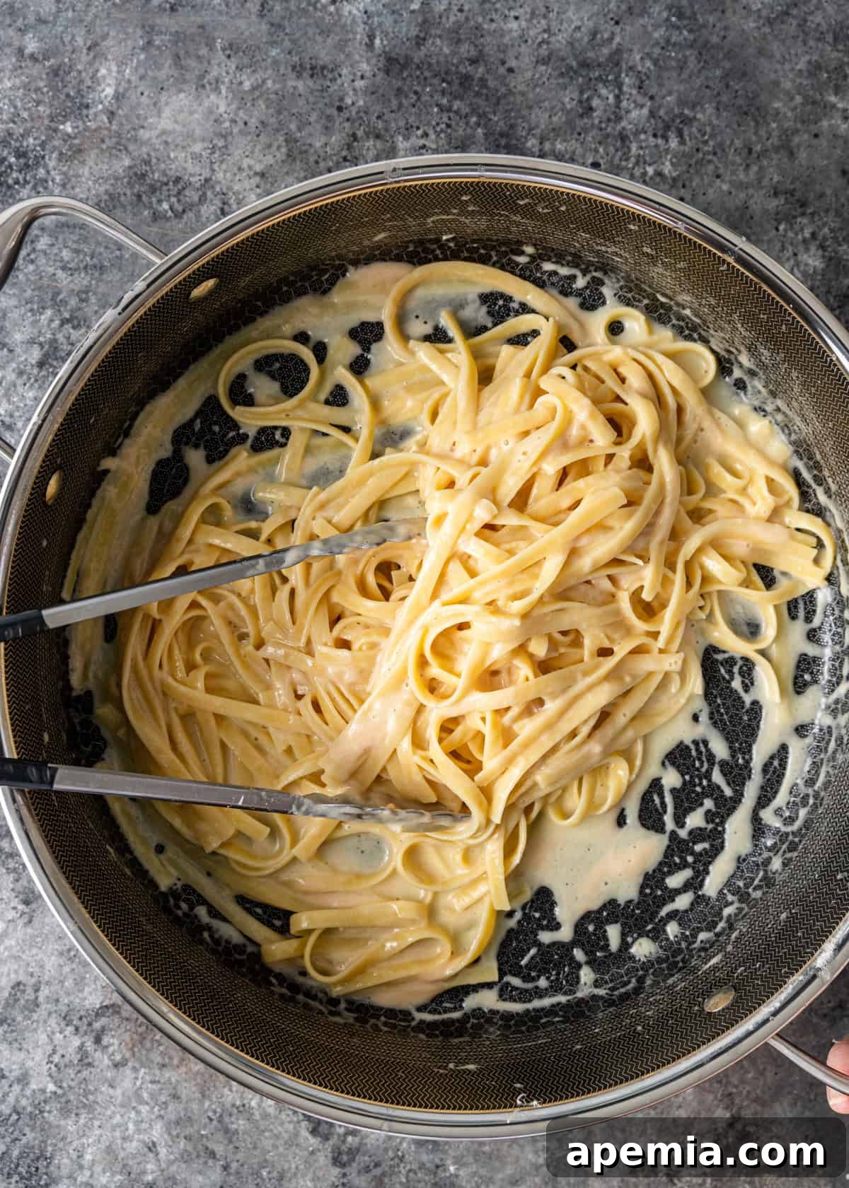 overhead process shot: finished creamy fettuccine alfredo in the skillet