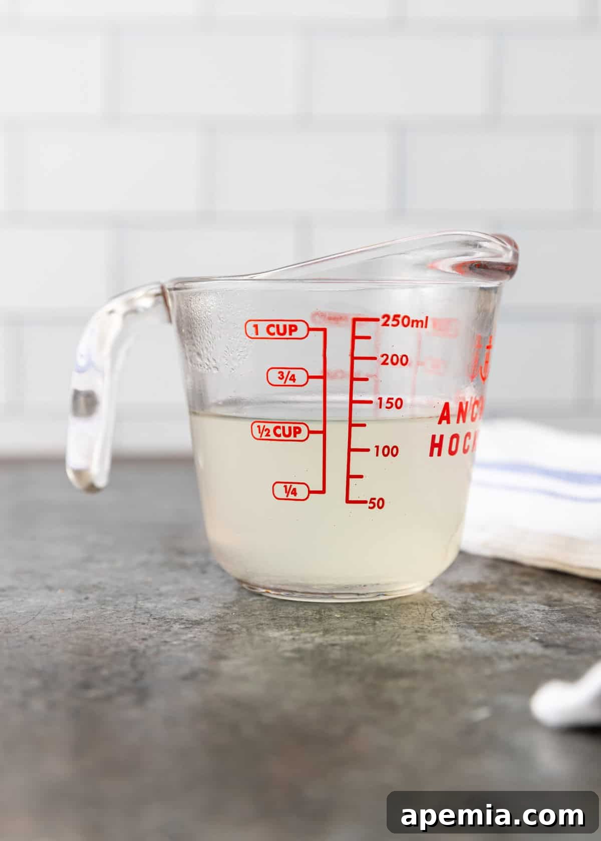 reserved pasta water in a glass measuring cup