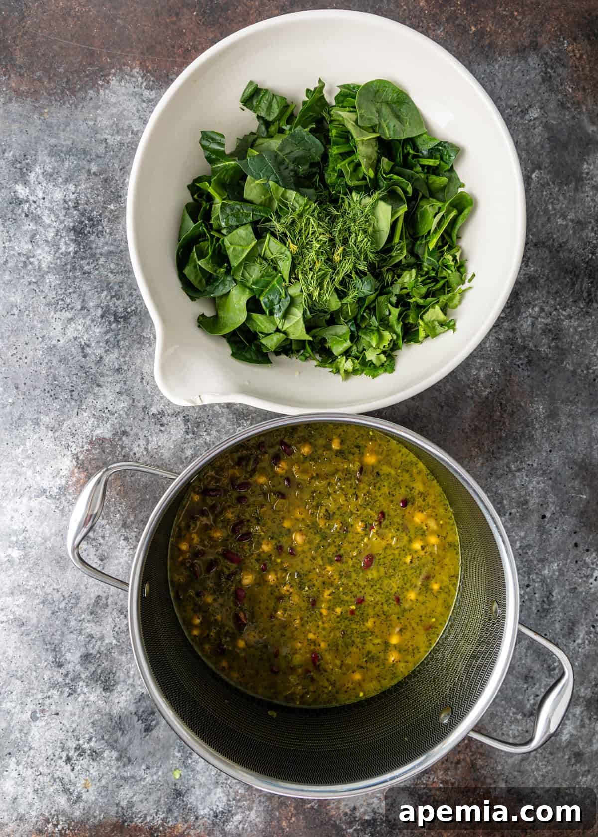 Overhead view of Iranian Noodle Soup with chopped fresh herbs ready to be added to the side or as a garnish.