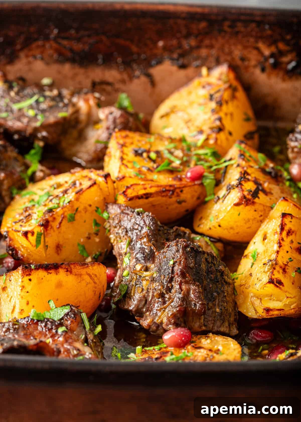 closeup: roasted beef chuck with potatoes in a baking dish