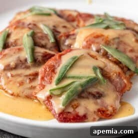 Final plated Saltimbocca alla Romana, showing tender meat, crispy prosciutto, and sage, with the rich white wine sauce.