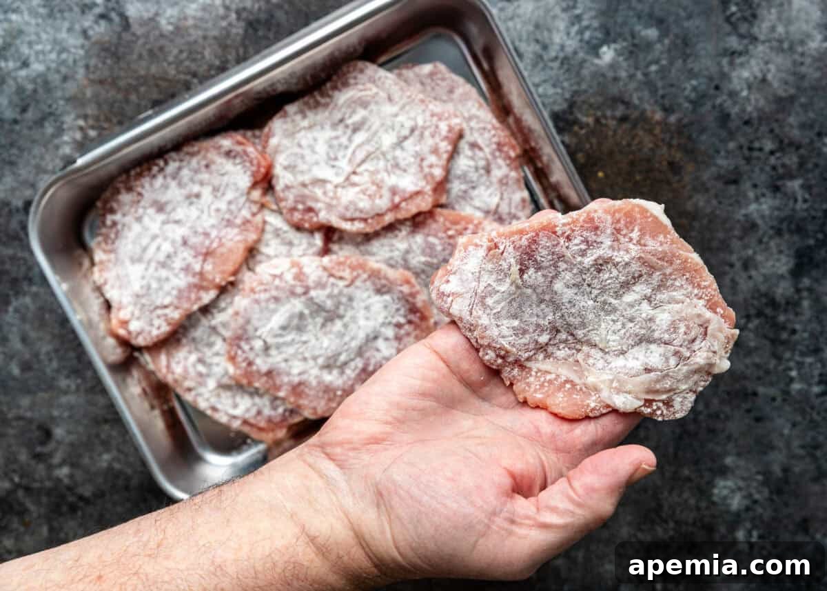 Process shot: The assembled pork, sage, and prosciutto cutlet lightly dusted with flour.