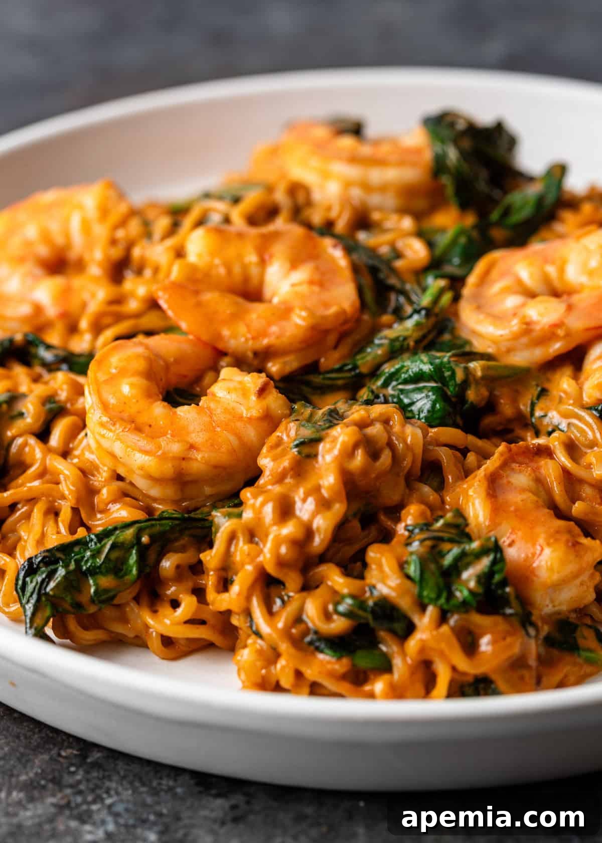 Zesty Gochujang Sesame Noodles 11 closeup side view: sesame gochujang noodles with shrimp and spinach