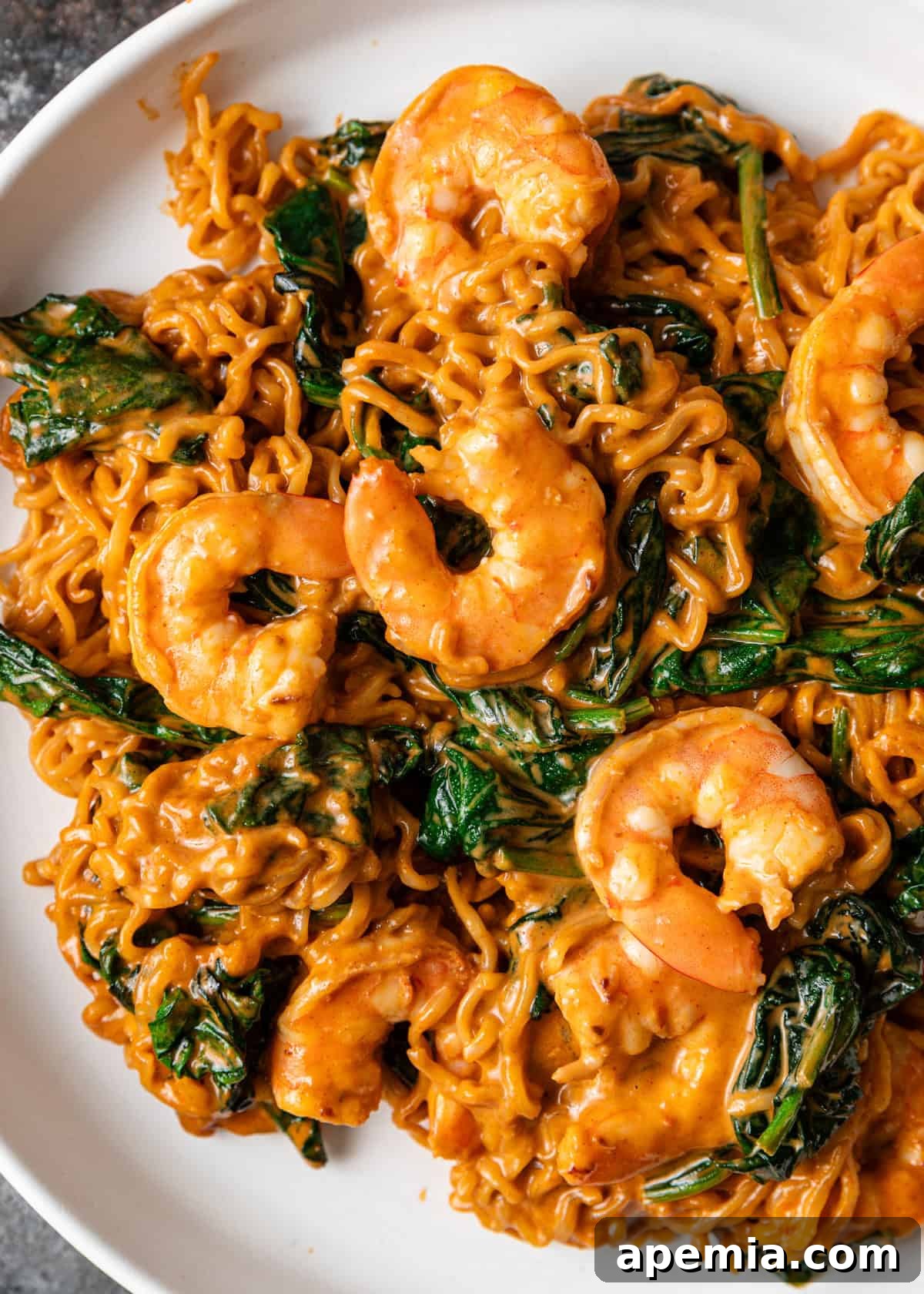 Zesty Gochujang Sesame Noodles 3 overhead closeup: sesame gochujang noodles with spinach and shrimp in sauce