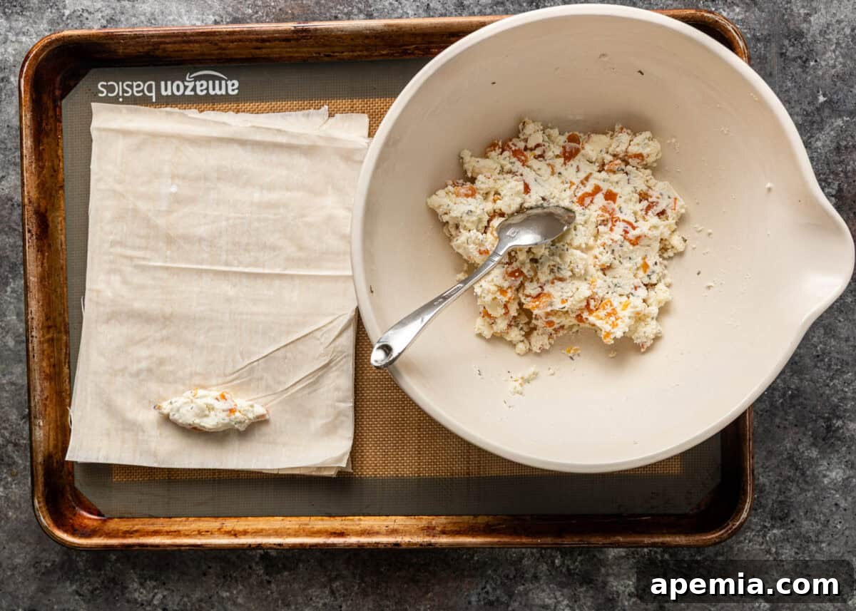 Golden Feta Börek Rolls 6 Overhead process shot: A teaspoon of feta filling placed on a quarter-sheet of phyllo dough.
