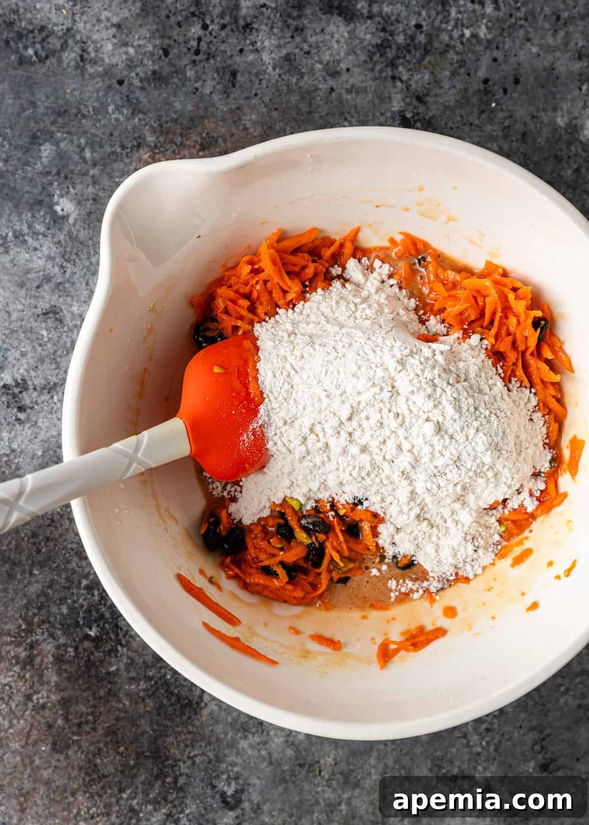 overhead process shot: adding the dry ingredients to the wet ones in a bowl