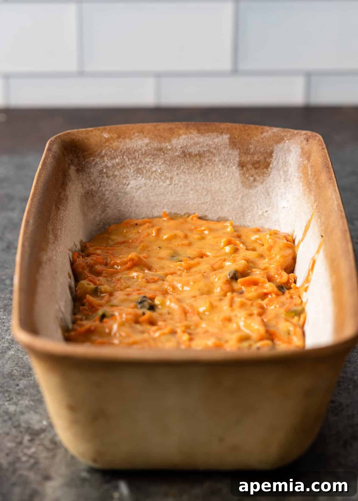 side view: carrot cake loaf in a loaf pan before baking
