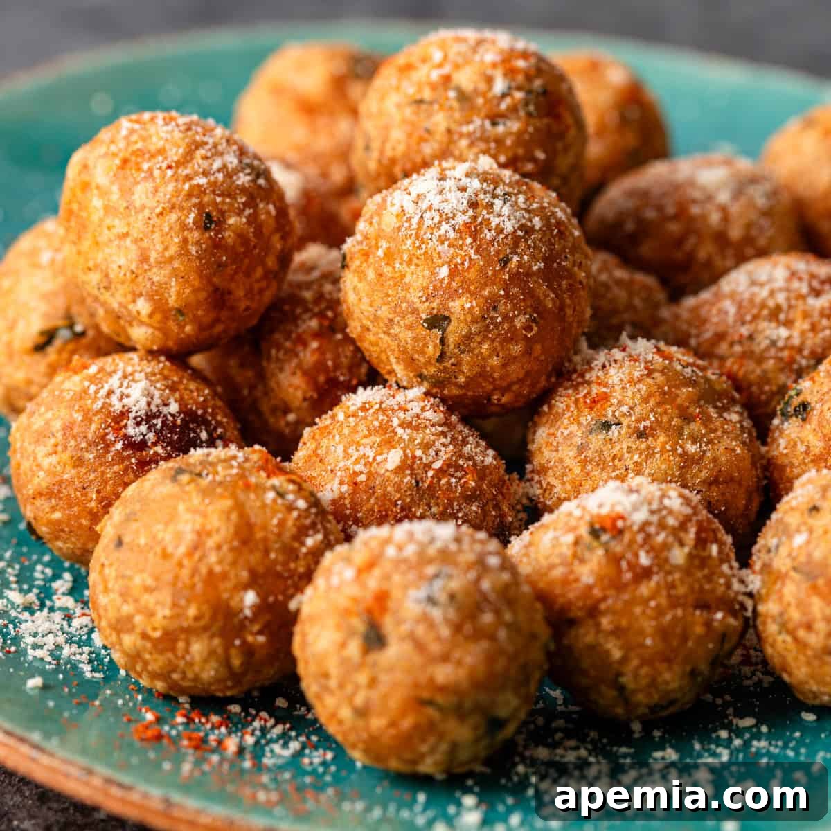 Closeup of a stack of crispy Aloo Tikki potato patties sprinkled with seasonings