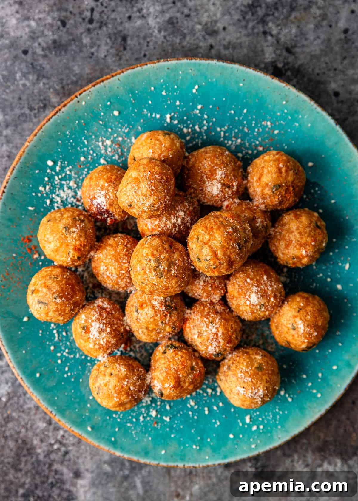 Overhead view of a stack of crispy potato patties on a blue plate