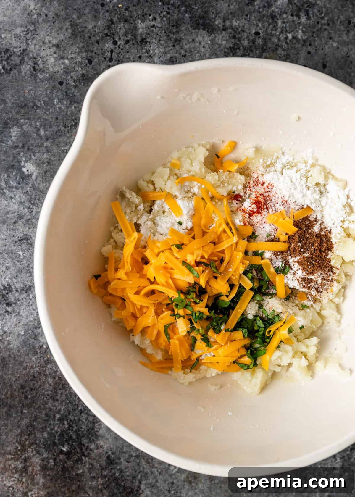 Overhead view of Aloo Tikki ingredients in a bowl before mixing