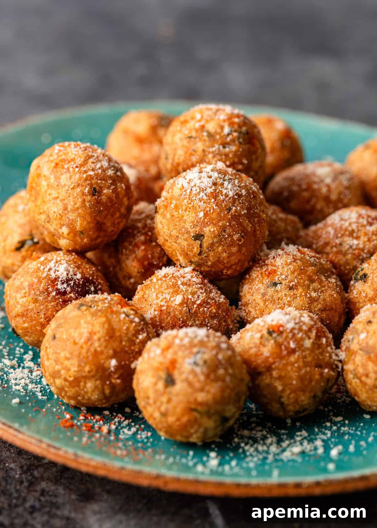 Side view closeup of a stack of seasoned crispy potato patties on a blue plate