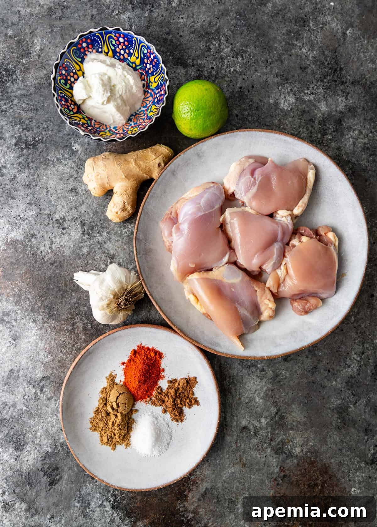 Overhead shot displaying all the fresh ingredients meticulously laid out for preparing the ruby chicken curry recipe.