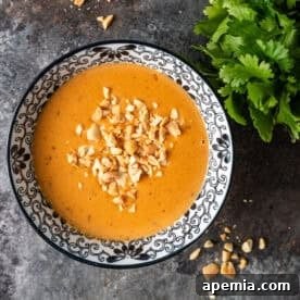 A beautifully presented bowl of creamy Thai Peanut Sauce, ready to be enjoyed.