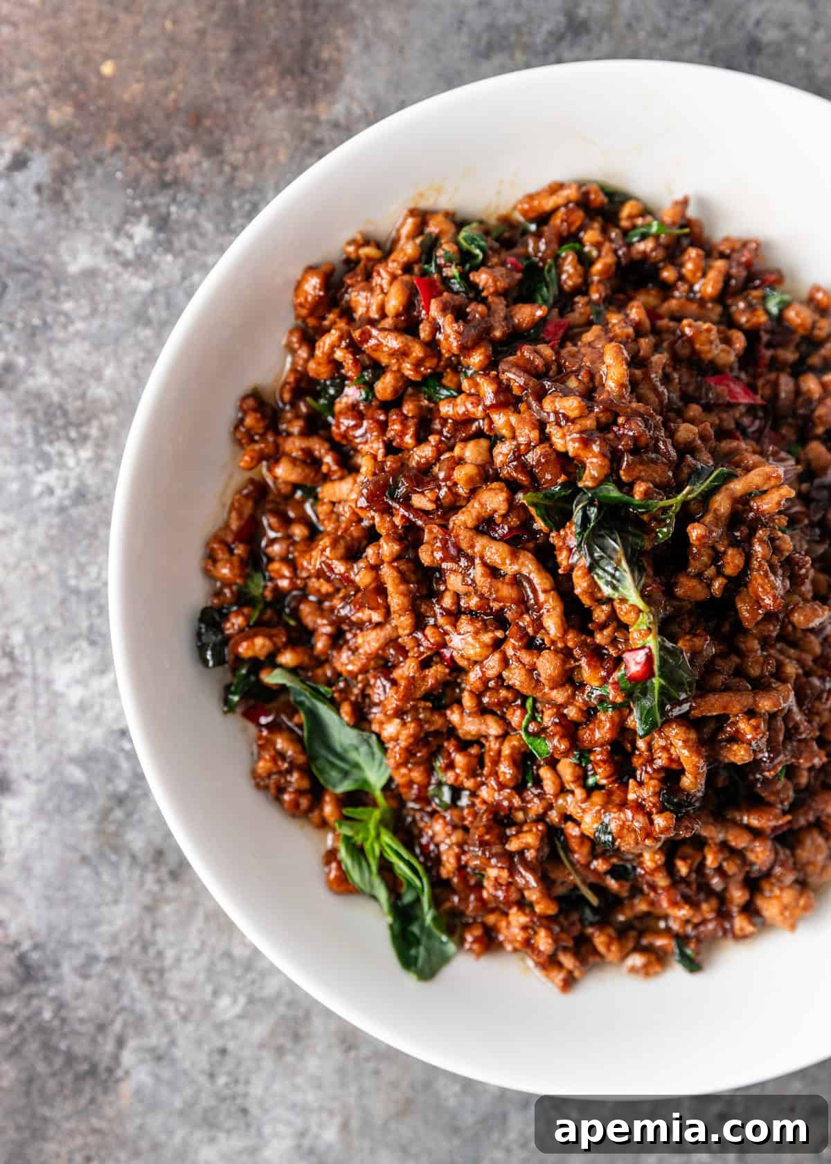 overhead: a bowl of pad krapow with holy basil on top