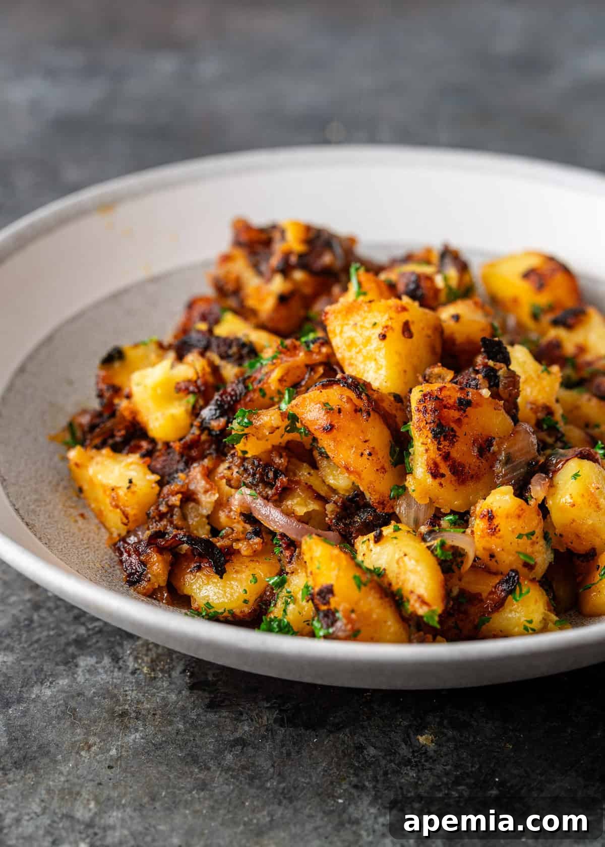 side view: a serving of crispy miso potatoes in a bowl