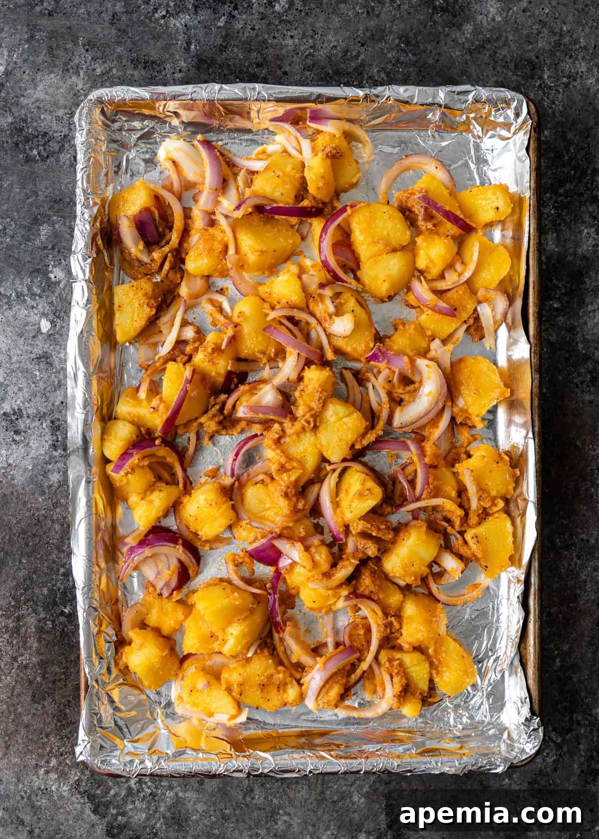 overhead process shot: miso potatoes on a baking sheet before roasting