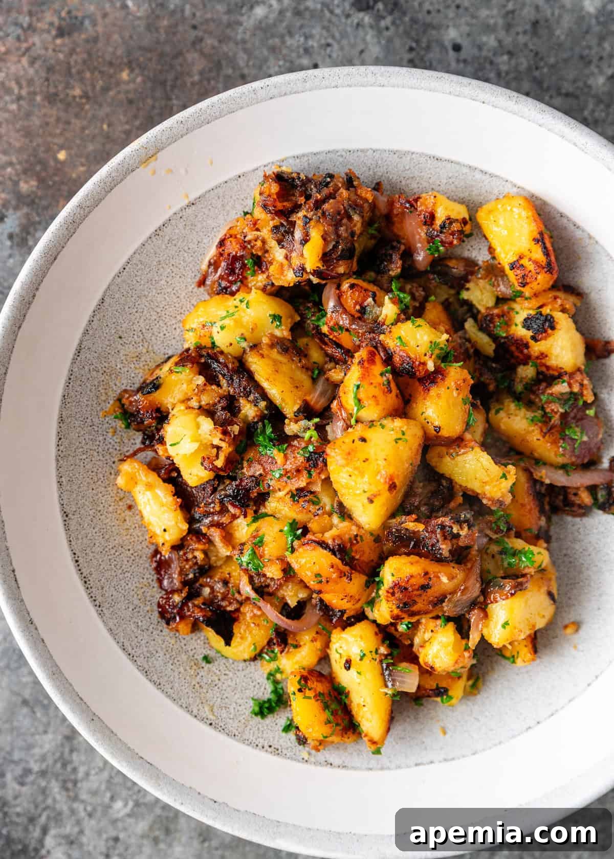 overhead: miso roasted potatoes on a white plate
