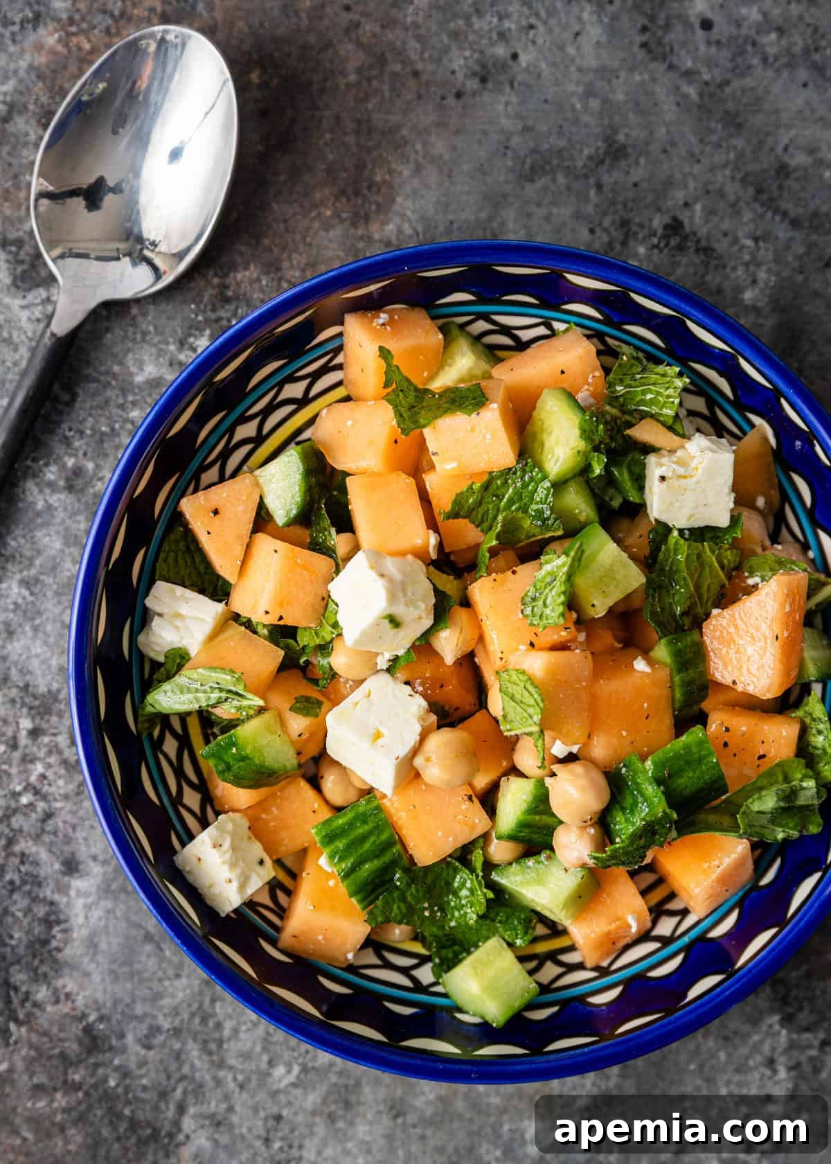 overhead: a serving of my melon salad recipe in a blue and white bowl, ready to eat