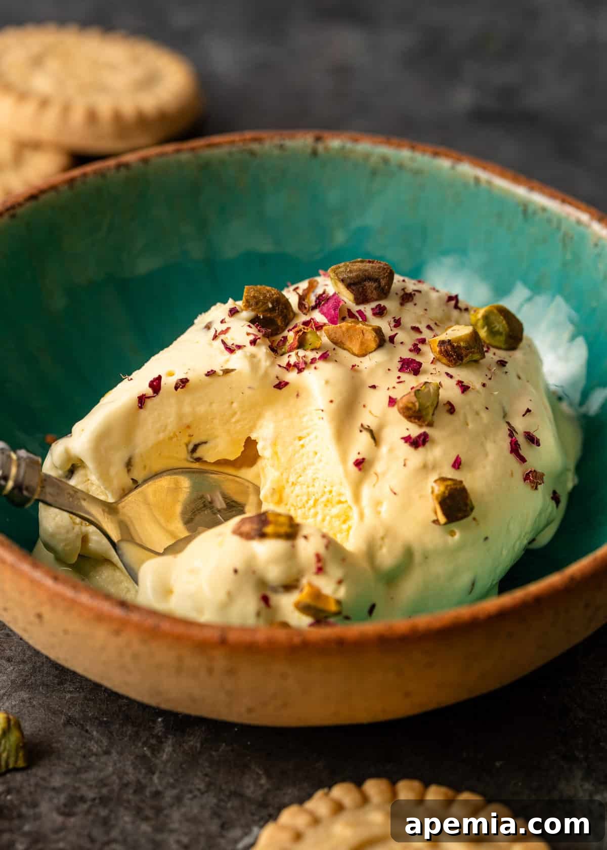 Closeup: A serving of homemade Persian ice cream (Bastani Sonnati) in a bowl, ready to be enjoyed with a spoon.